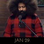 Image of Reggie Watts wearing a red buffalo check sweater on Comedy Bang! Bang!
