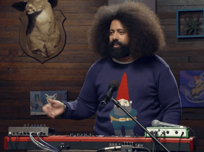 REggie at his keyboard, wearing a gnome sweater
